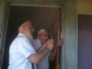 Rabbi Hecht helping Max Solomon put up his Mezuza